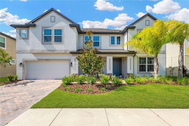 view of front facade featuring a garage and a front lawn