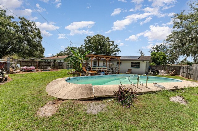 view of pool featuring a lawn and a patio