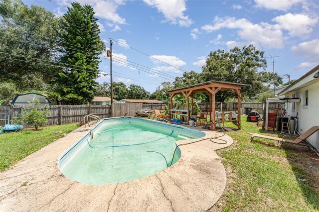 view of pool with a lawn, a patio, and a gazebo