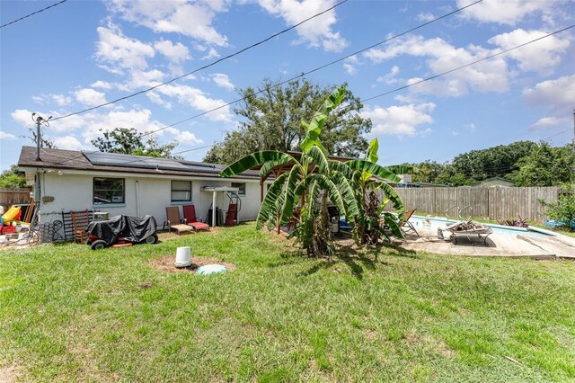 view of yard with a fenced in pool