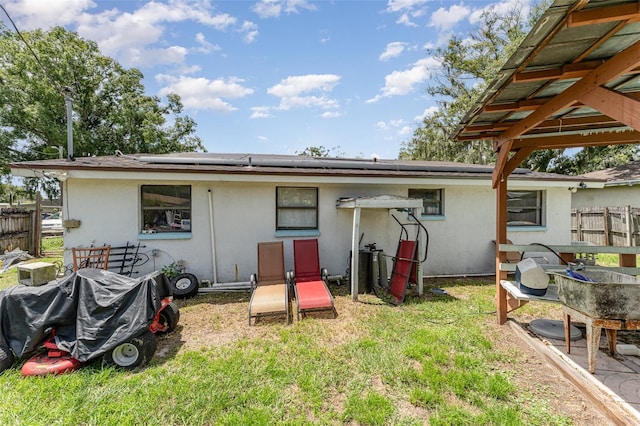 rear view of house with a lawn and a patio area