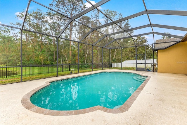 view of swimming pool featuring a lanai and a patio