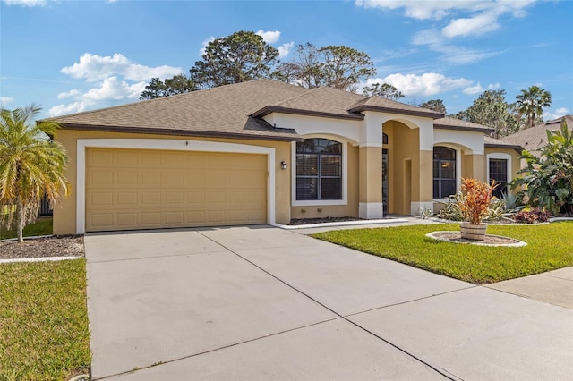 view of front of house featuring a garage and a front lawn