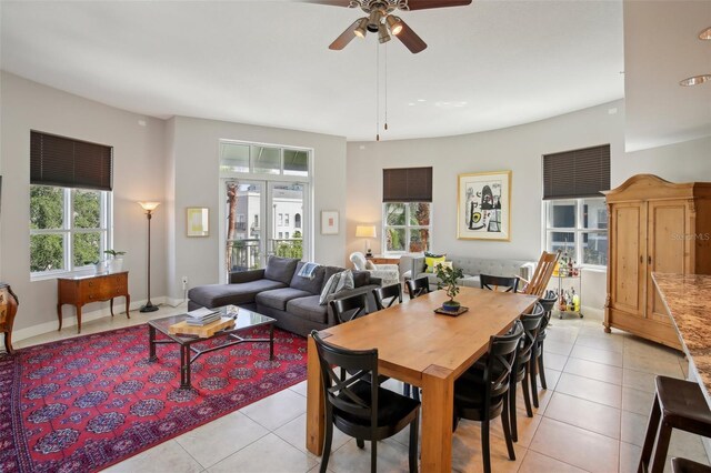 dining room featuring baseboards, a ceiling fan, and light tile patterned flooring