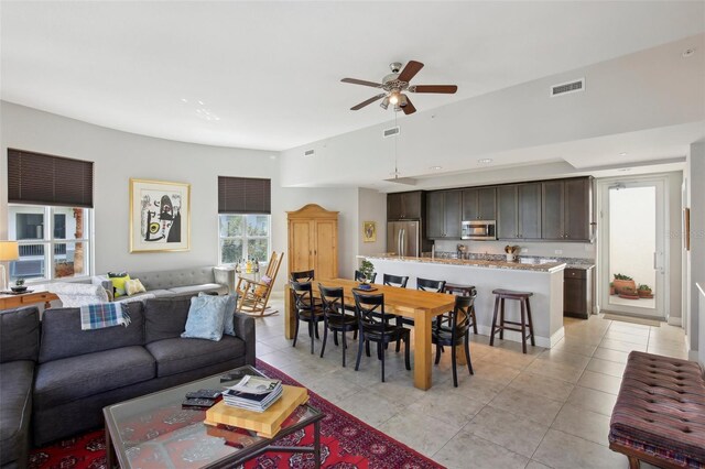 living area with a ceiling fan, recessed lighting, visible vents, and light tile patterned floors