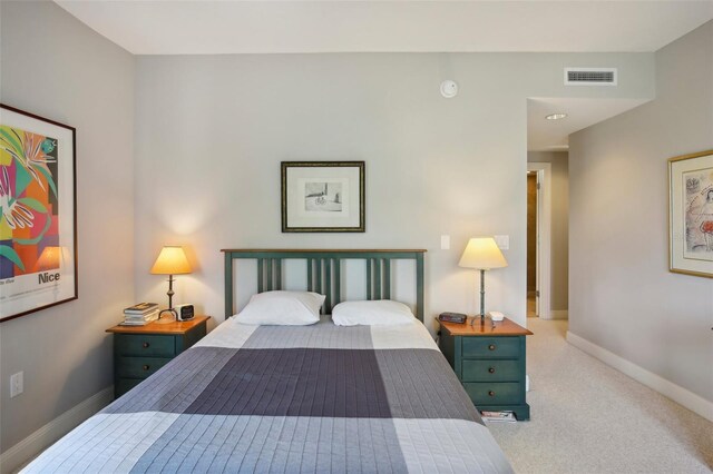 bedroom with carpet, visible vents, and baseboards