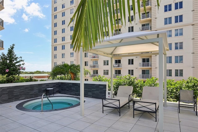 view of swimming pool with a hot tub