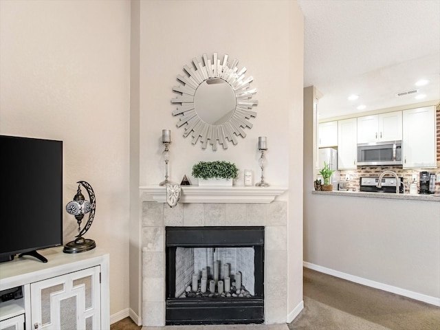 living room featuring a fireplace and carpet floors