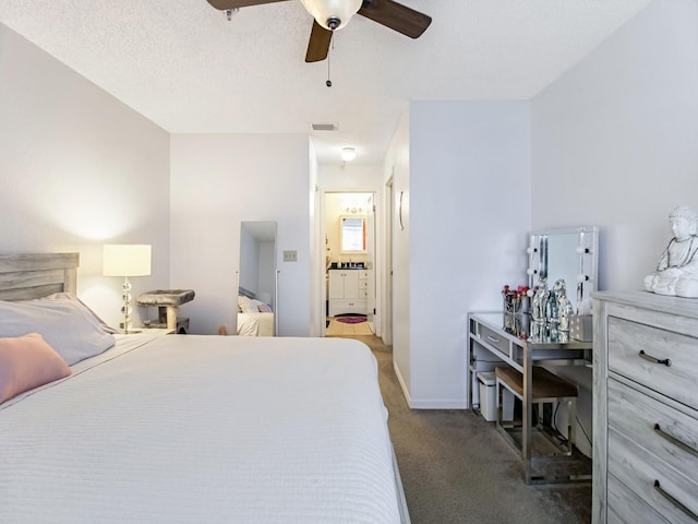 carpeted bedroom with ceiling fan and a textured ceiling