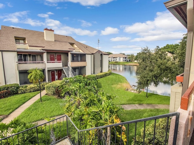 exterior space featuring a water view and a lawn