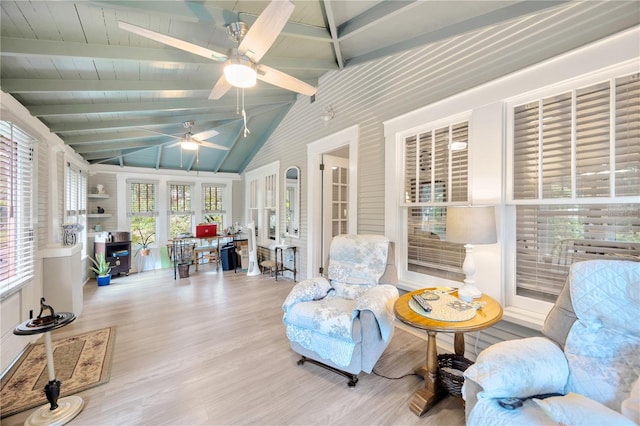 sunroom with ceiling fan, vaulted ceiling with beams, and french doors