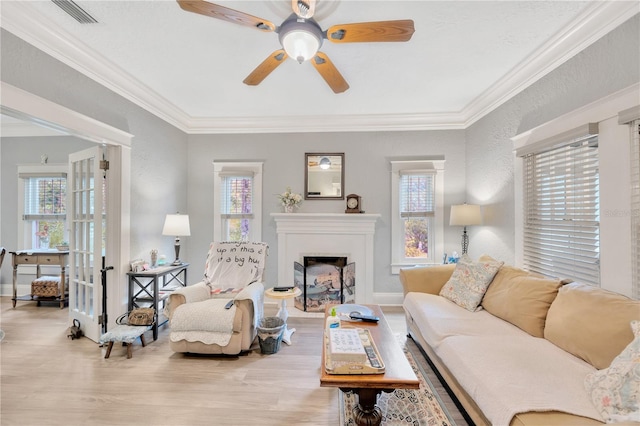 living room with french doors, light hardwood / wood-style flooring, ceiling fan, and a wealth of natural light