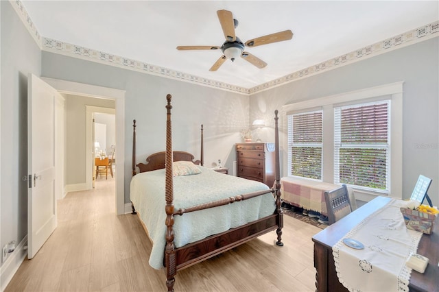 bedroom with light wood-type flooring, radiator heating unit, and ceiling fan