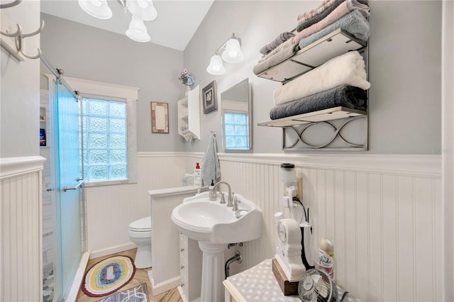 bathroom featuring an enclosed shower, hardwood / wood-style floors, toilet, and lofted ceiling