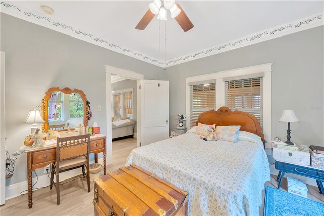 bedroom with light hardwood / wood-style flooring and ceiling fan