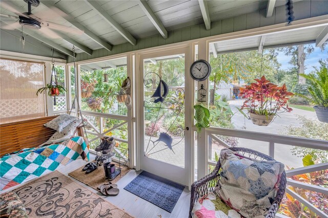 sunroom with wood ceiling, ceiling fan, and vaulted ceiling with beams