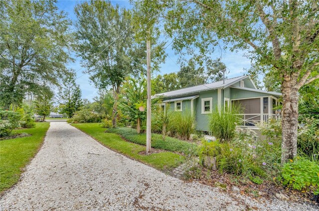 view of side of property featuring a sunroom