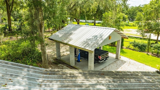 view of vehicle parking featuring a yard and a carport