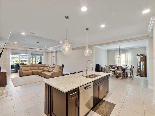 kitchen featuring light stone countertops, an island with sink, stainless steel dishwasher, sink, and ceiling fan