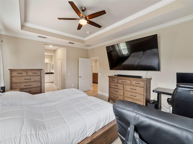 bedroom featuring crown molding, a raised ceiling, light tile patterned flooring, ceiling fan, and connected bathroom