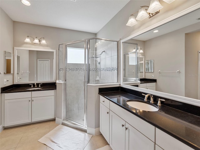 bathroom with vanity, an enclosed shower, and tile patterned floors