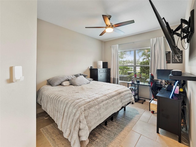 tiled bedroom featuring ceiling fan