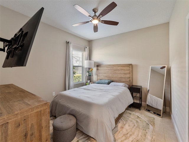 tiled bedroom featuring ceiling fan