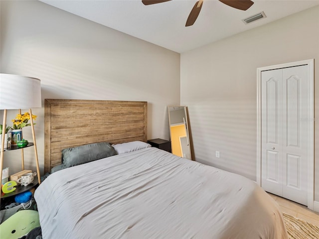 bedroom with ceiling fan and a closet