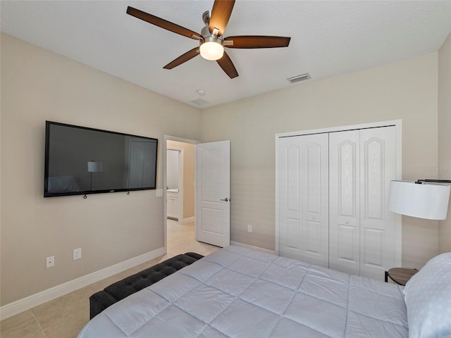 bedroom featuring a closet, ceiling fan, and light tile patterned floors