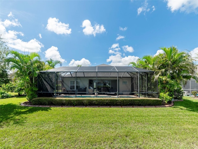 rear view of property with glass enclosure and a lawn