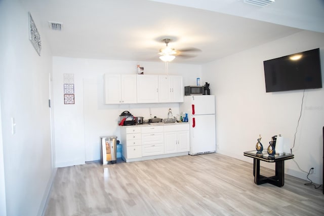 kitchen featuring light hardwood / wood-style flooring, ceiling fan, white cabinets, and white fridge