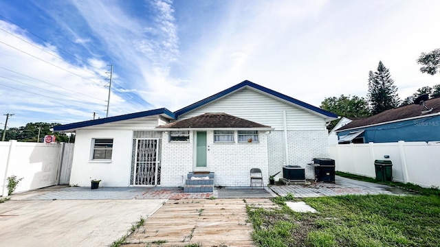 2503 W Marquette Ave, Tampa, FL 33614 - rear view of house featuring a patio area, central air condition unit, and brick siding