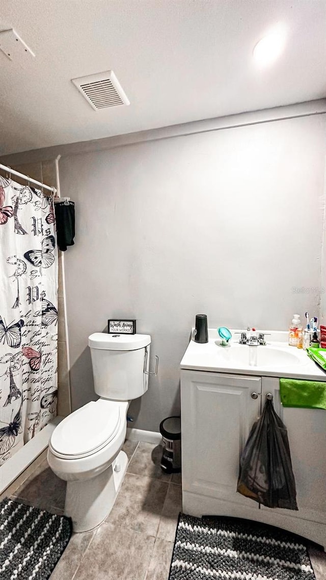 bathroom with a shower with shower curtain, toilet, and vanity