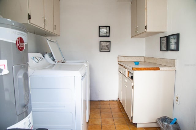 washroom with separate washer and dryer, cabinets, light tile patterned floors, and water heater