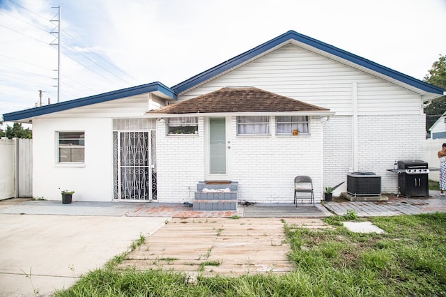 rear view of house with a patio area and central air condition unit