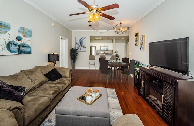 living room with ceiling fan with notable chandelier, ornamental molding, and dark hardwood / wood-style floors