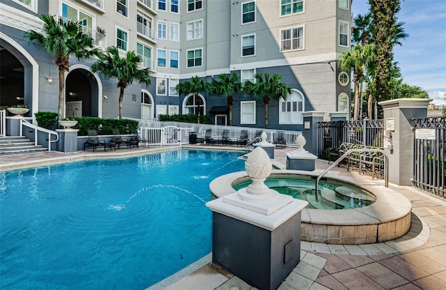 view of pool featuring a hot tub and a patio