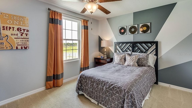 carpeted bedroom featuring a ceiling fan and baseboards