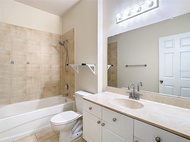 full bathroom with toilet, vanity, tile patterned floors, and tiled shower / bath