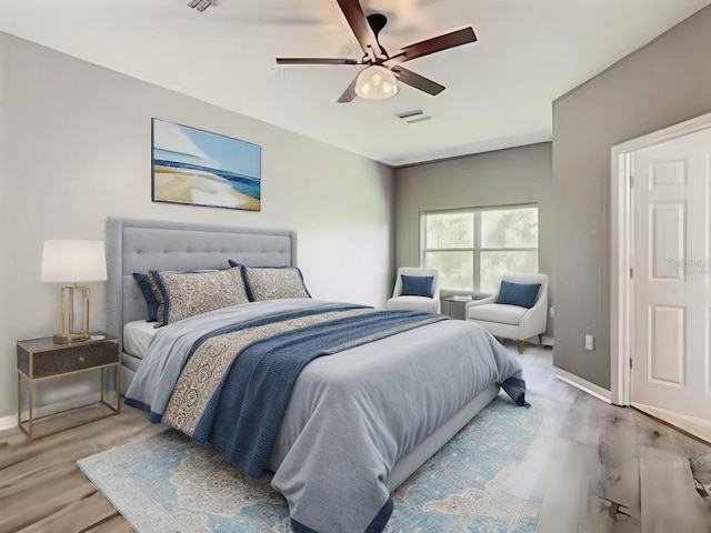 bedroom with ceiling fan and hardwood / wood-style flooring