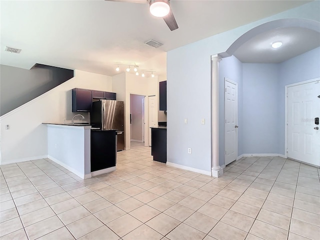 kitchen with light tile patterned floors, decorative columns, stainless steel refrigerator, and ceiling fan