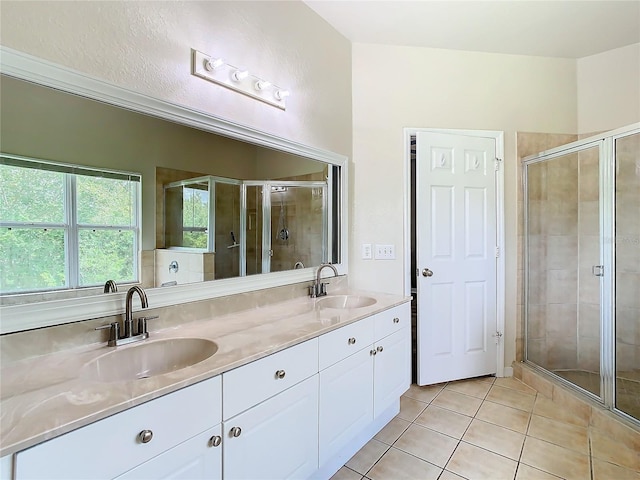 bathroom featuring tile patterned flooring, vanity, and walk in shower