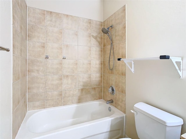 bathroom with tiled shower / bath combo and toilet