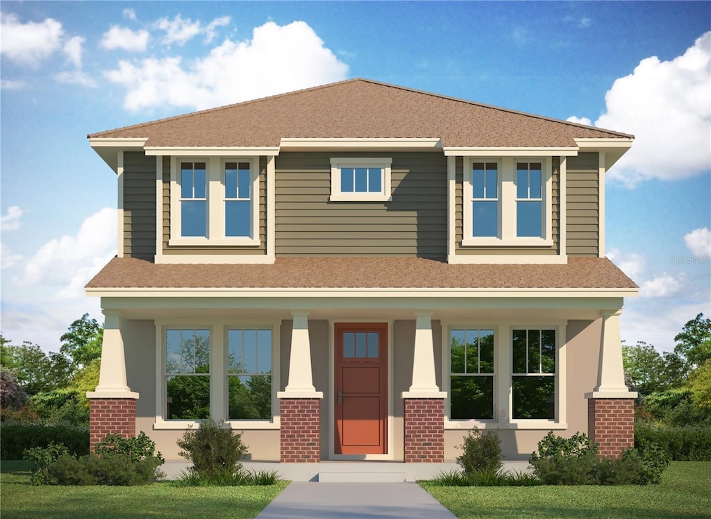 view of front of home featuring brick siding, covered porch, and roof with shingles