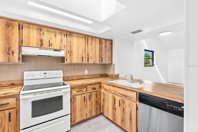 kitchen with vaulted ceiling, light hardwood / wood-style flooring, stainless steel dishwasher, sink, and white range with electric cooktop