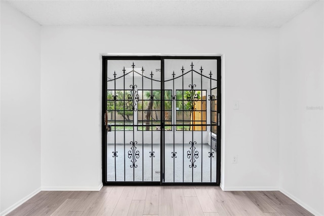 doorway with light hardwood / wood-style flooring