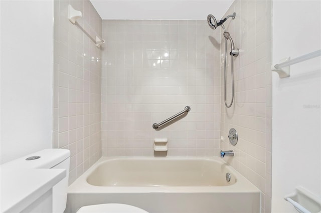 full bathroom with tiled shower / bath, toilet, and vanity