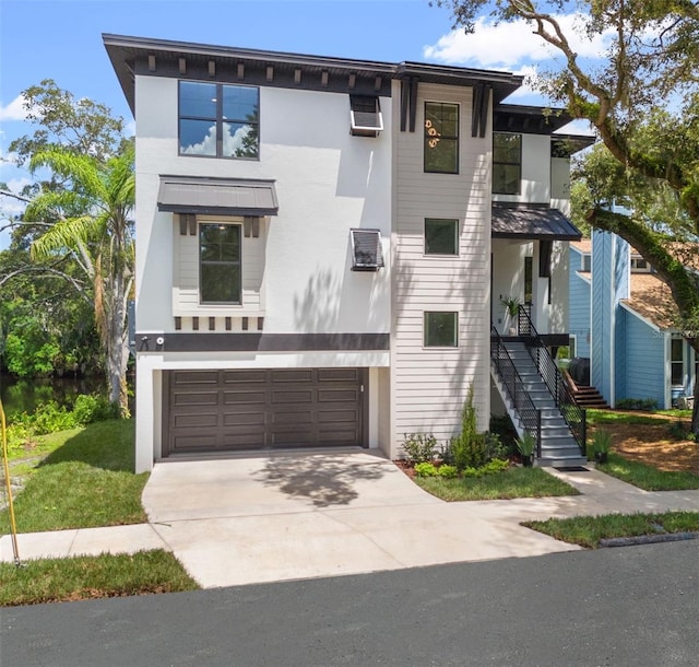 contemporary home with a garage and a wall unit AC