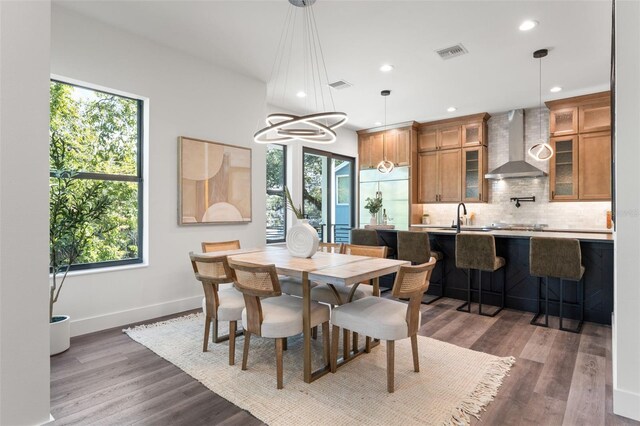 dining area with a healthy amount of sunlight and dark hardwood / wood-style floors