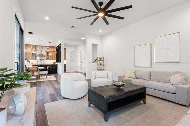 living room featuring ceiling fan and light wood-type flooring